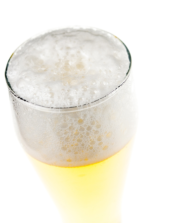 cold mug of beer with foam isolated on white backgroundの写真素材
