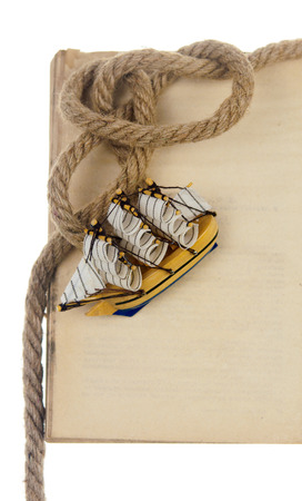 empty old book and model classic boat, rope isolated on white backgroundの写真素材