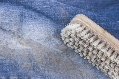 clothes cleaning brush on blue jeansの写真素材