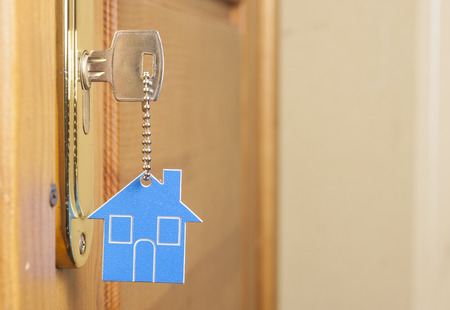 Symbol of the house and stick the key in the keyhole の写真素材