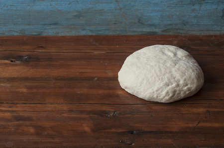 A ball of unbaked dough lightly covered in flour.の写真素材