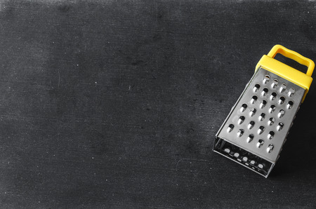 Cheese grater on a wood kitchen tableの写真素材