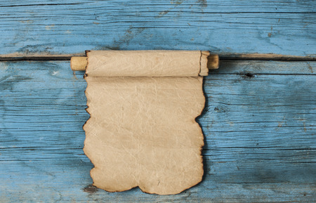 Ancient scroll on wooden table close upの写真素材