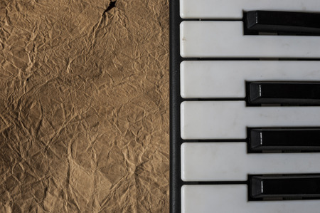 Black and white keys of an old piano on blank vintage paper