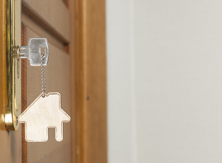 Symbol of the house and stick the key in the keyhole の写真素材
