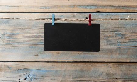 Black notice board with copy space on wooden backgroundの写真素材