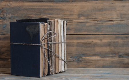 Beautiful very antique books on wooden tableの写真素材