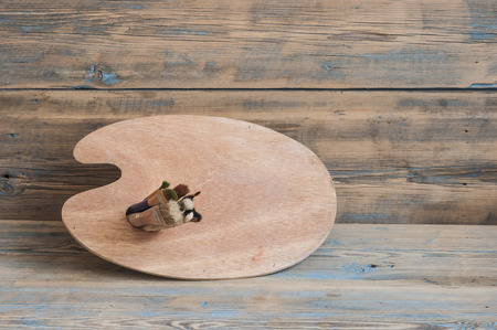 Painter palette on a wooden  background. Copy spase, space for text. の写真素材