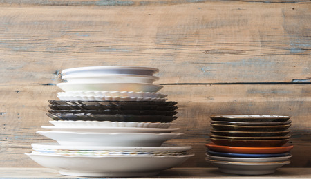 Stack of empty plate for dinner on wooden table