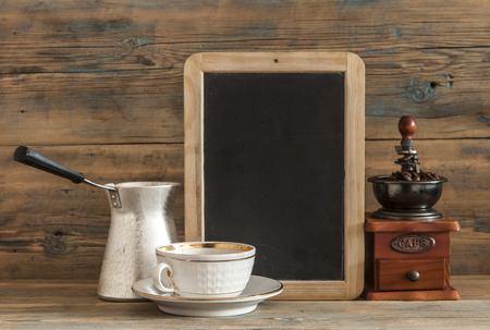 sweet hot drink : black turkish coffee in small white mug coffee beans on wooden tableの写真素材