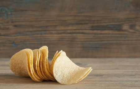 Crispy potato chips on wooden boardsの写真素材