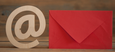 E-mail at symbol and envelope on a desk の写真素材