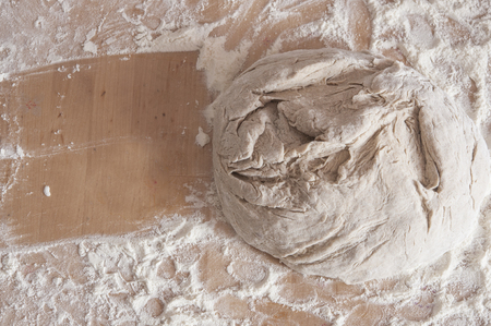 knead dough on wooden table, is ready. Top viewの写真素材