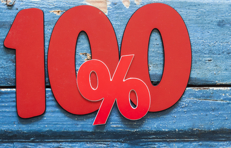 Number 100 and percent sign on wooden backgroundの写真素材
