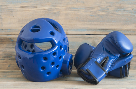 set Taekwondo equipment on a wooden background stock photos. Sports, martial arts. Protective equipment for fight in full contactの写真素材
