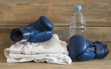set Taekwondo equipment on a wooden background stock photos. Sports, martial arts. Protective equipment for fight in full contactの写真素材