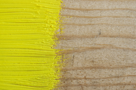 yellow paint on old wooden backgroundの写真素材