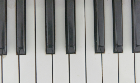 Close up of the white and black keys on a piano