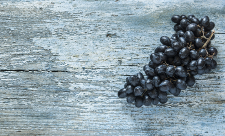 Grapes bunch on a old wooden background. Top view , copy space .の写真素材