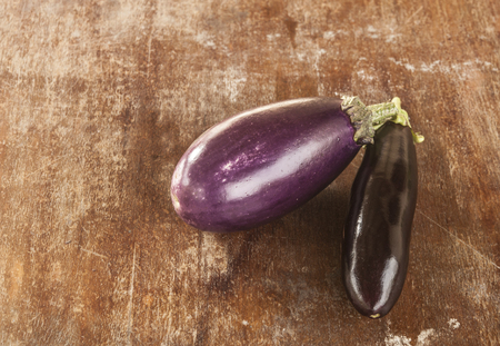 Two eggplants on a wooden surfaceの写真素材