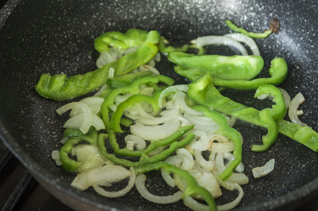 a pan full of peppers and onionsの写真素材