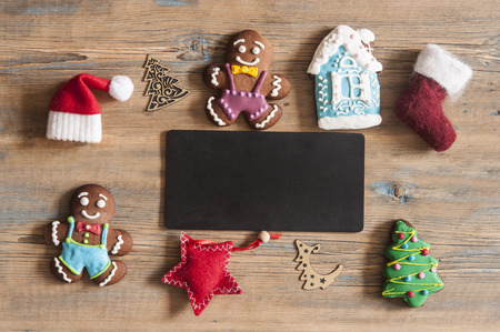 Blackboard with santa claus hat and christmas decoration on wood rustic background with copy space for textの写真素材