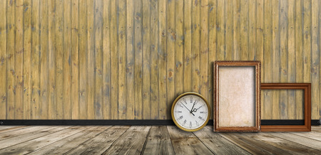 Empty vintage interior with wooden  wall, clock and blank frameの写真素材