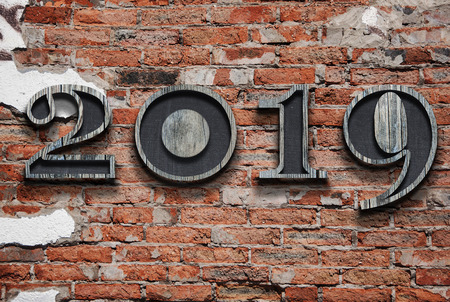 New years resolution 2019 concept. Wooden year number on brick wall with copy space for your text