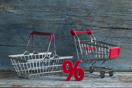 Shopping cart and sign percent with sale concept on wood backgroundの写真素材