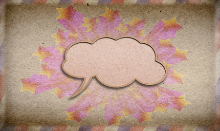 blank signboard in the shape of a speech bubble  against vintage paper background.の写真素材