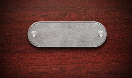 Wooden background with a metal labelの写真素材