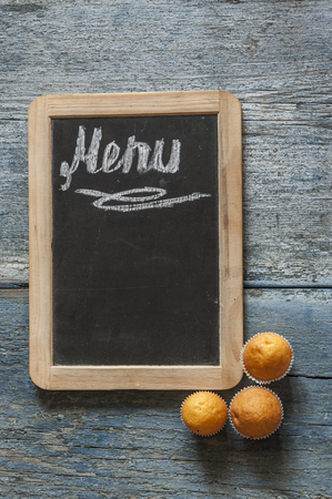 Menu text on a chalkboard on wooden tableの写真素材
