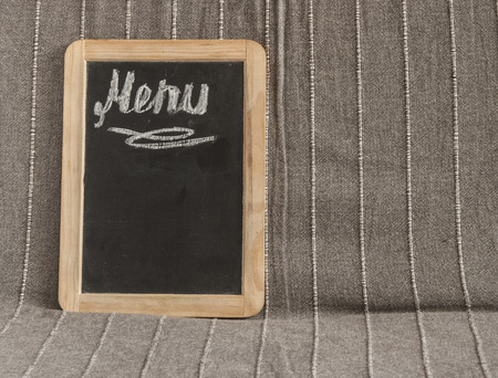 Menu text on a chalkboard on wooden tableの写真素材