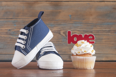 Festive background decoration for birthday celebration with delicious Ñupcakes for a baby shower on wooden backgroundの写真素材