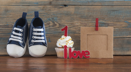 Festive background decoration for birthday celebration with delicious Ñupcakes for a baby shower on wooden backgroundの写真素材