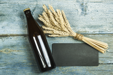 bottle of beer on a wooden backgroundの写真素材