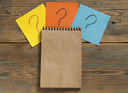 Paper with question mark icon on the wooden backgroundの写真素材