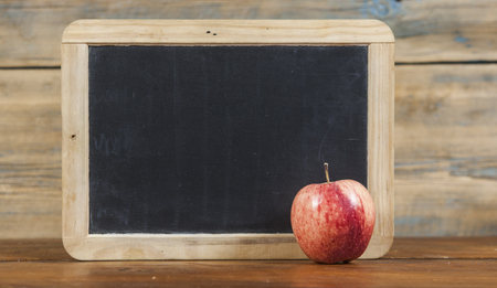 Black school board for your text. The apple is red for lunch and snack after classes. Copy space.の写真素材