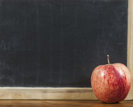 Black school board for your text. The apple is red for lunch and snack after classes. Copy space.の写真素材