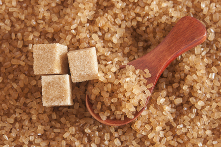 Healthy cane sugar on old wooden spoonの写真素材