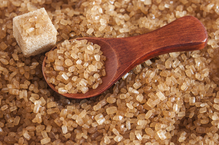 Healthy cane sugar on old wooden spoonの写真素材