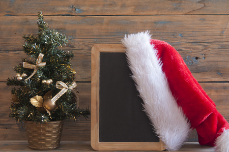 Christmas tree with decorations and presents on wooden table backgroundの写真素材