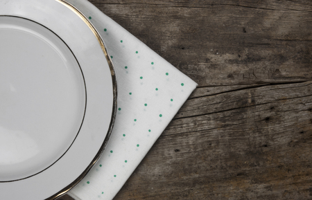 Top view of white empty plate. Ceramic plate on wooden background.の写真素材