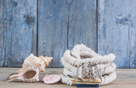 Seashells and marine rope on wooden table. Marine backgroundの写真素材