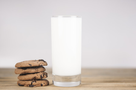 Chocolate chip cookies, milk, rustic wood backgroundの写真素材