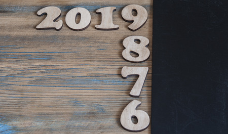 New years resolution 2019 concept. Wooden year number on table with copy space for your textの写真素材