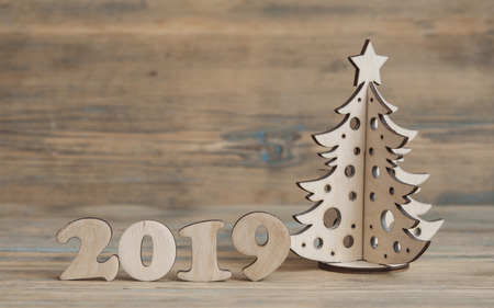 Christmas greeting card. Christmas decoration with text 2019 on wooden backgroundの写真素材