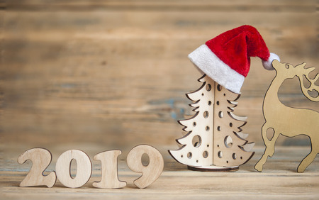 Christmas greeting card. Christmas decoration with text 2019 on wooden background
