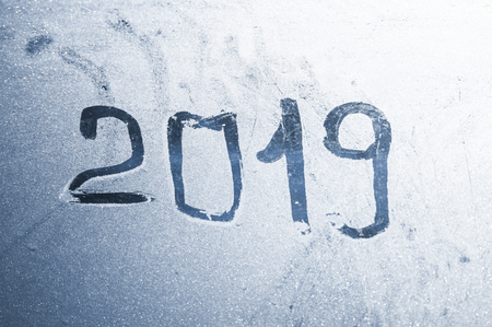 Beautiful crispy frost structure on a window with cold blue gradient light.の写真素材