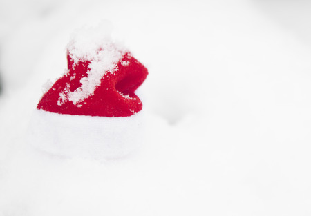 Christmas background with frosty pine tree with red Santa hat